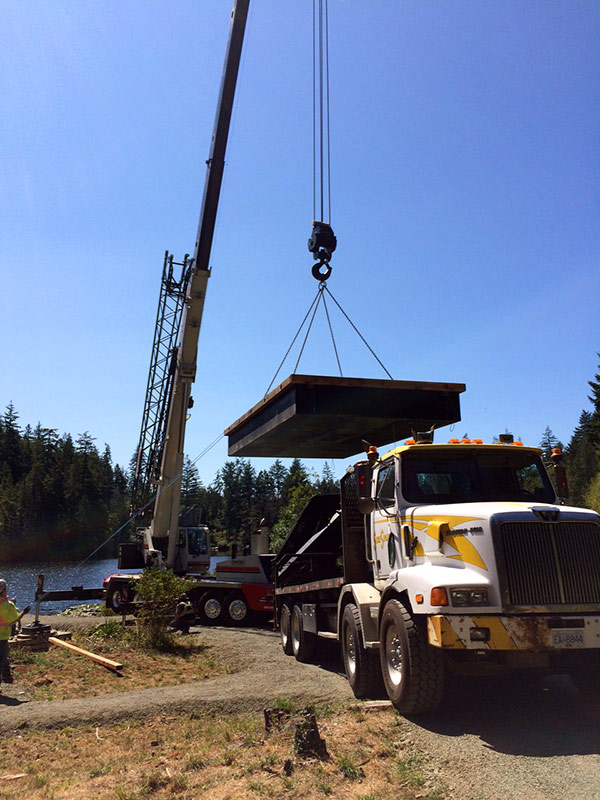 One of two new docks is lifted into place on Poirier Lake (click on photo for larger image)